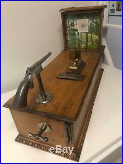 Early table model FRENCH gun shooting game with token pay-out for a winner