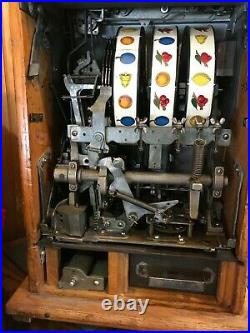 Jennings Chief Slot Machine & Mills War Eagle Slot machines & Ornate oak stand