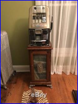 Mills 777, quarter Slot Machine, With Money Box. Including Stand