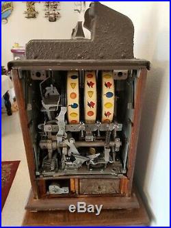 Mills Novelty Company 50-Cent Brown Front Slot Machine and Ornate Stand