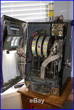 Vintage mills slot machine and oak stand